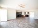 Spacious open-concept living room featuring hardwood floors, ceiling fan, and natural light at 15 Golden Poppy Ln, Youngsville, NC 27596