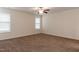 This bedroom includes carpet, a ceiling fan, and two windows at 151 Goose Creek Cir, Dunn, NC 28334