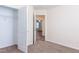 Carpeted bedroom with open closet reveals neutral paint and access to a second room at 151 Goose Creek Cir, Dunn, NC 28334