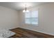 Bright dining area featuring wood floors and a modern chandelier at 151 Goose Creek Cir, Dunn, NC 28334