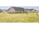 Well-maintained single-story home with beige siding and a large front lawn at 151 Goose Creek Cir, Dunn, NC 28334