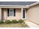 Close-up of home's front door and window, complemented by well-maintained landscaping at 151 Goose Creek Cir, Dunn, NC 28334