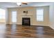 Spacious living room with a cozy fireplace and new hardwood flooring at 151 Goose Creek Cir, Dunn, NC 28334