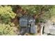 Aerial view of a home with mature landscaping, a long driveway, and a backyard deck among the trees at 1965 Wedgewood Dr, Sanford, NC 27332