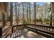 This backyard deck overlooks a tranquil forest and features a built-in bench for relaxing in the shade at 1965 Wedgewood Dr, Sanford, NC 27332
