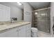 Updated bathroom with granite countertops, white vanity and glass shower, offering a modern touch at 1965 Wedgewood Dr, Sanford, NC 27332