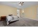Spacious bedroom with ceiling fan, neutral walls and carpet, and an attached bathroom at 1965 Wedgewood Dr, Sanford, NC 27332