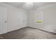 Clean and simple bedroom with carpet, natural light, and double closet doors for ample storage at 1965 Wedgewood Dr, Sanford, NC 27332