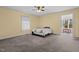 Cozy bedroom features a ceiling fan, carpet flooring, and access to an outdoor patio at 1965 Wedgewood Dr, Sanford, NC 27332
