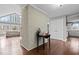 Inviting entryway with brick accent wall, hardwood floors, and views into the brightly lit living spaces at 1965 Wedgewood Dr, Sanford, NC 27332