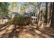 This brick home offers mature trees, a side entry garage, a manicured yard, and architectural shingles at 1965 Wedgewood Dr, Sanford, NC 27332