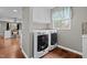 Functional laundry room with front loading washer and dryer and additional storage above at 1965 Wedgewood Dr, Sanford, NC 27332