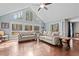 Bright living room with floor-to-ceiling windows, hardwood floors, and comfortable seating arrangements at 1965 Wedgewood Dr, Sanford, NC 27332
