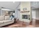 Open-concept living room featuring a cozy fireplace, hardwood floors, and seamless flow into dining and kitchen areas at 1965 Wedgewood Dr, Sanford, NC 27332