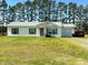 Charming one-story home with a well-maintained lawn and attached garage, nestled among tall trees at 20 Golden Poppy Ln, Youngsville, NC 27596