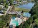An aerial view of the community pool, tennis courts, and a nearby lake at 200 Nottinghill Walk, Apex, NC 27502