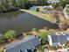 Aerial view of lakeside townhomes with well-maintained lawns and close proximity to community amenities at 200 Nottinghill Walk, Apex, NC 27502