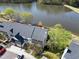Aerial perspective of townhomes featuring attached garages, set near a picturesque lake at 200 Nottinghill Walk, Apex, NC 27502