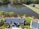 An aerial view of townhomes with manicured lawns close to a serene lake and community green space at 200 Nottinghill Walk, Apex, NC 27502