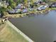 Aerial view of lakeside townhomes with walking paths and a serene water view at 200 Nottinghill Walk, Apex, NC 27502
