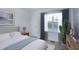 Bright bedroom with white bedding, a large window and neutral decor at 200 Nottinghill Walk, Apex, NC 27502