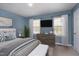 The bedroom features lots of natural light, a TV, and en suite bathroom at 200 Nottinghill Walk, Apex, NC 27502