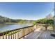 Spacious deck with railing overlooking scenic lake and trees at 200 Nottinghill Walk, Apex, NC 27502
