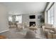 Inviting living room features a fireplace, neutral tones, and lots of natural light at 200 Nottinghill Walk, Apex, NC 27502