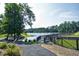 Scenic view of a wooden bridge over a pond surrounded by lush trees and a peaceful atmosphere at 200 Nottinghill Walk, Apex, NC 27502