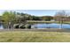 Community water view featuring a walking path, mature trees, and landscaping at 200 Nottinghill Walk, Apex, NC 27502