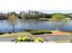 Water view featuring mature trees, landscaping, and a community walking path at 200 Nottinghill Walk, Apex, NC 27502