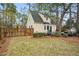 Backyard featuring a privacy fence, mature trees, a wooden deck and a well-manicured lawn at 204 Arnold Ln, Fuquay Varina, NC 27526