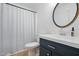 Updated bathroom with new vanity, mirror, and shower-tub combination at 204 Arnold Ln, Fuquay Varina, NC 27526