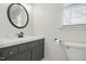 Contemporary bathroom features sleek fixtures and a large round mirror at 204 Arnold Ln, Fuquay Varina, NC 27526