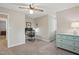 Bright bedroom featuring neutral walls, carpet, ceiling fan, and ample natural light at 204 Arnold Ln, Fuquay Varina, NC 27526