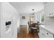 Open dining area with hardwood floors, chandelier, and adjacent kitchen at 204 Arnold Ln, Fuquay Varina, NC 27526