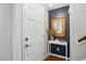 Stylish entryway with a white door, accent table, and decorative mirror at 204 Arnold Ln, Fuquay Varina, NC 27526