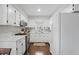Bright kitchen with white cabinets, stainless steel appliances, and hardwood floors at 204 Arnold Ln, Fuquay Varina, NC 27526