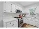 Updated kitchen with stainless steel appliances, white cabinets, and bright countertops at 204 Arnold Ln, Fuquay Varina, NC 27526