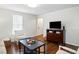 Well-lit living room with hardwood floors, accent furniture, and entertainment center at 204 Arnold Ln, Fuquay Varina, NC 27526