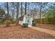 Storage shed in a wooded backyard setting, surrounded by tall trees and a privacy fence at 204 Arnold Ln, Fuquay Varina, NC 27526