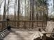 Wooden deck surrounded by trees, furnished with comfortable seating for outdoor relaxation at 2217 Magnolia Tree Ln, Durham, NC 27703