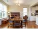 Bright dining room with hardwood floors, natural light, and open access to the kitchen at 2217 Magnolia Tree Ln, Durham, NC 27703