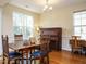 Bright dining room with hardwood floors, natural light, and charming traditional furniture at 2217 Magnolia Tree Ln, Durham, NC 27703