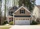 Charming two-story home featuring a two-car garage, well-maintained lawn, and beautiful curb appeal at 2217 Magnolia Tree Ln, Durham, NC 27703