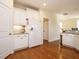 Well-lit kitchen with white cabinets, stainless steel appliances, and hardwood floors at 2217 Magnolia Tree Ln, Durham, NC 27703