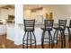 Kitchen bar area with granite countertop, pendant lighting, and white cabinets at 2217 Magnolia Tree Ln, Durham, NC 27703