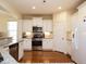 Bright kitchen with white cabinetry, stainless steel appliances, and granite countertops at 2217 Magnolia Tree Ln, Durham, NC 27703