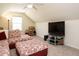 Bright living room features patterned sofa, a TV on stand, and a window providing natural light at 2217 Magnolia Tree Ln, Durham, NC 27703