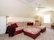 Comfortable living room featuring a patterned sectional sofa, ottoman, and ceiling fan at 2217 Magnolia Tree Ln, Durham, NC 27703